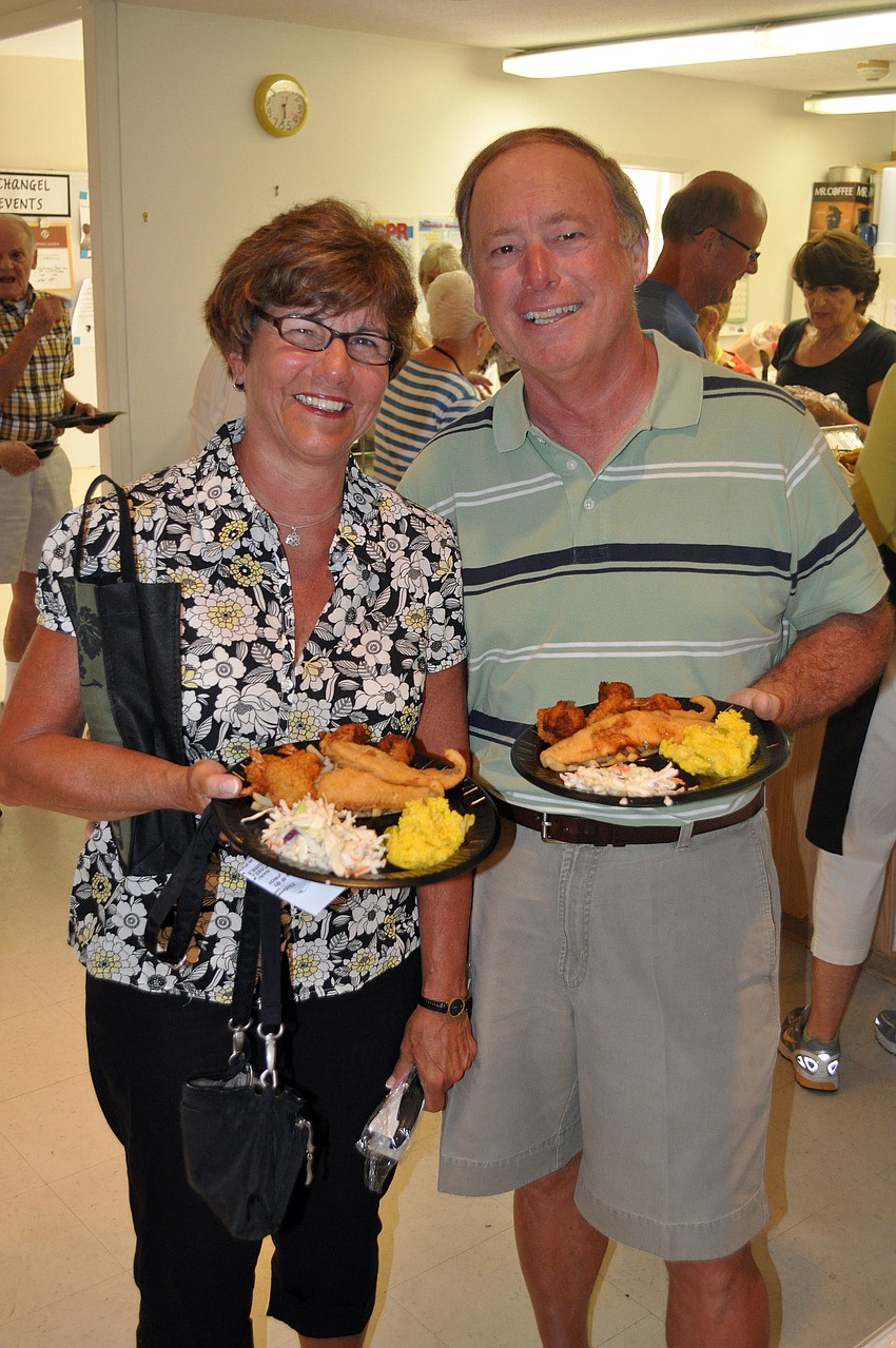 Pat and Charlie Elia show off their plates of food before sitting down for their Lent dinner, Friday, March 23, at St. Michael the Archangel.