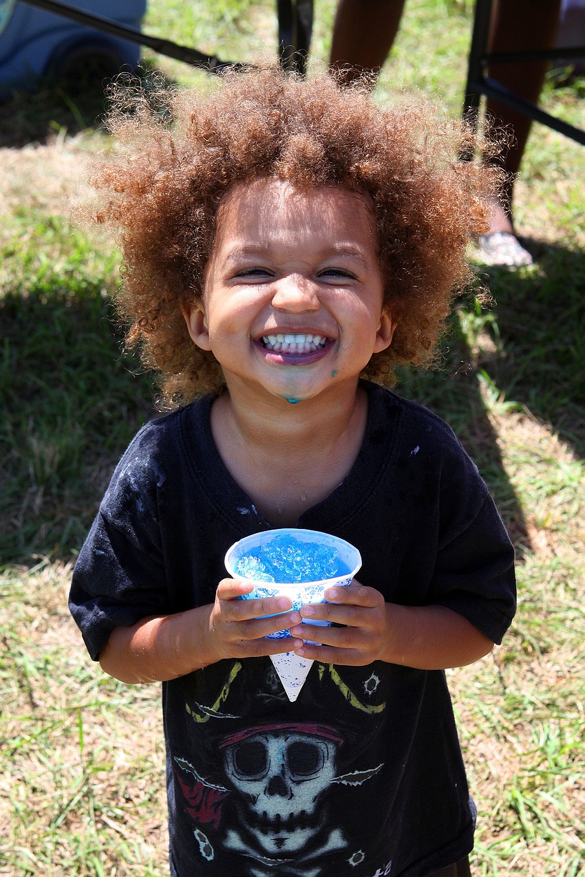 Bradley Alexander, 2, smiles big while enjoying his blue snow cone.