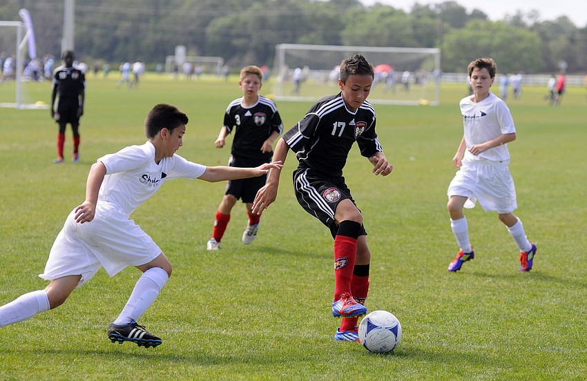 FC Americaâ€™s Austin Dâ€™Anna looks to control the ball and move up field past a defender.