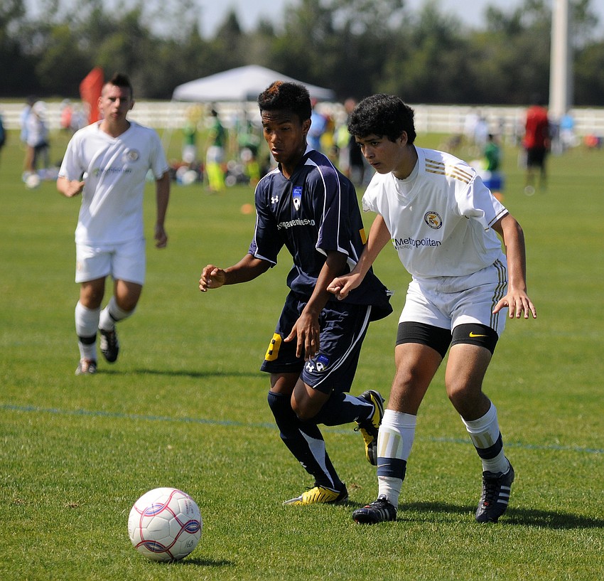IMG Soccer Academyâ€™s Daniel Chacon and Real Madrid Castillaâ€™s Jose Vicente race to control the ball.