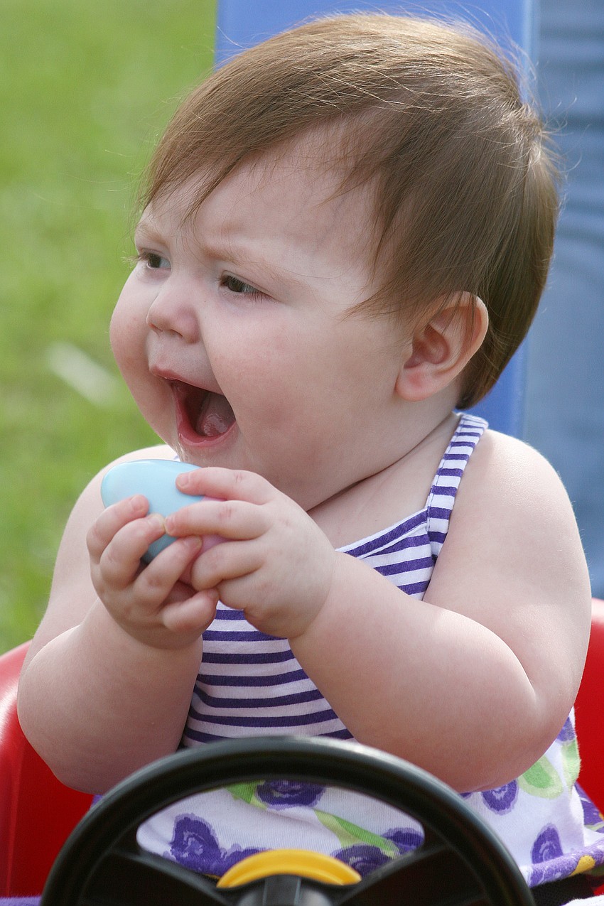 While some kids grabbed dozens of eggs, Shyanna Senevey, 9 months, was happy with just one.