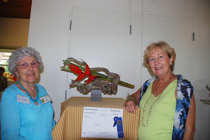 Hostess Liz Sutliff and Judith Ewing in front of their favorite arrangement by Christ Dermody