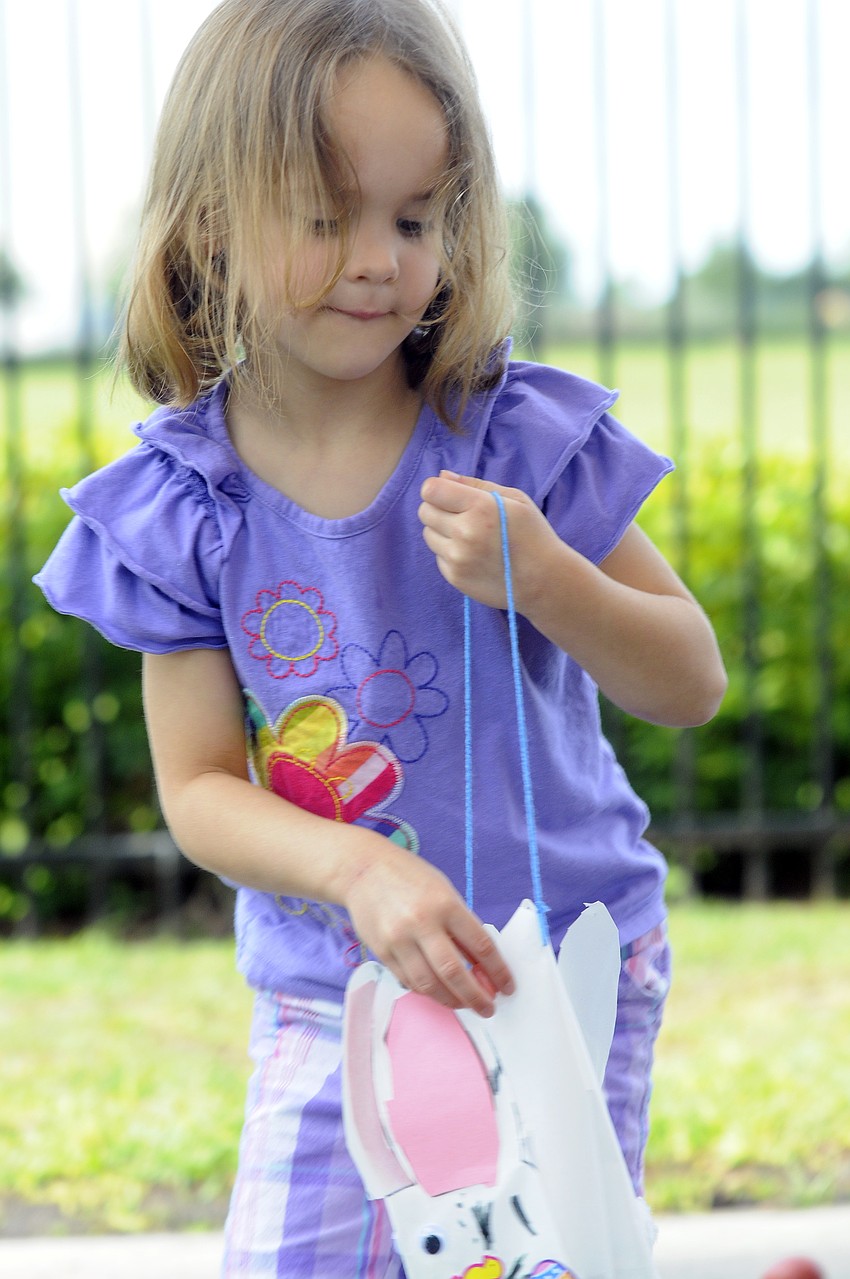 Natalia Chadbourne, 4, carefully places another egg in her Easter Bunny bag.
