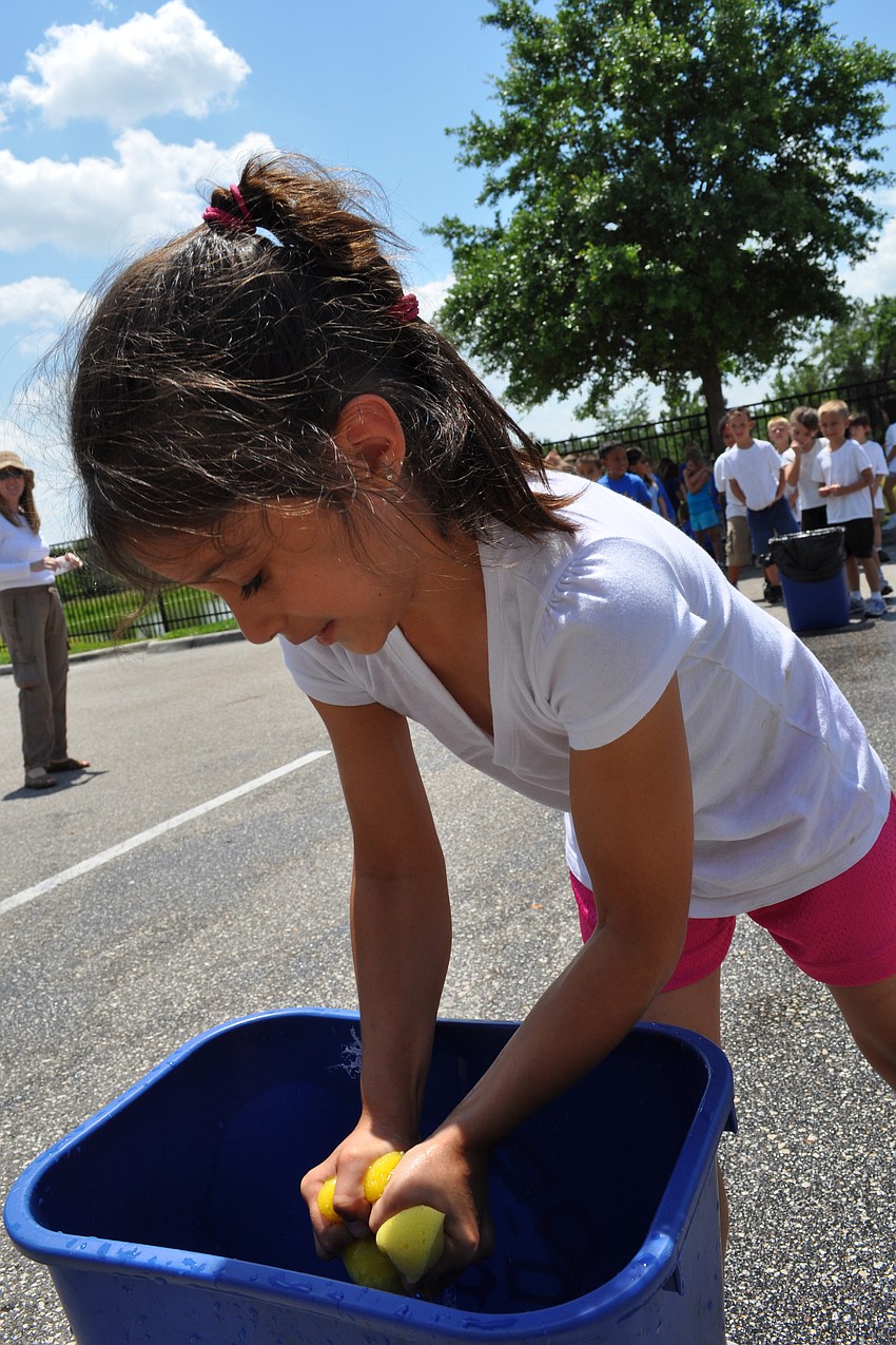 First-grader Jenna Holmes participated in a wet sponge squeeze race.