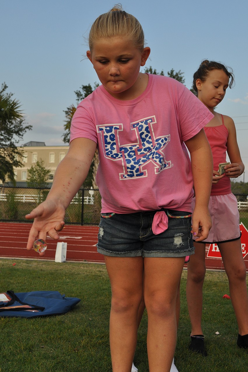 Averie Robinson, 10, tried to toss a ball into a cup.