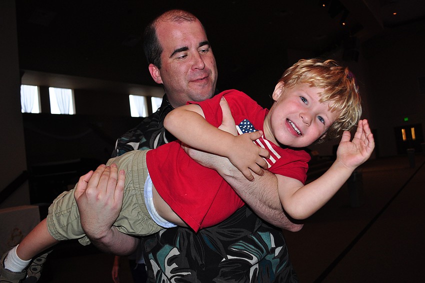 Micah Kennedy, 2, got a lift from his dad, Mike.