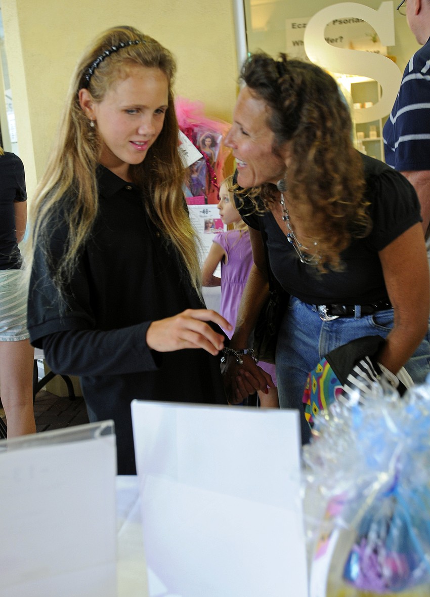 Nolan Middle School seventh-grader Racheal Jaworski enjoyed looking at all of the different silent auction items with her mom Wendy.