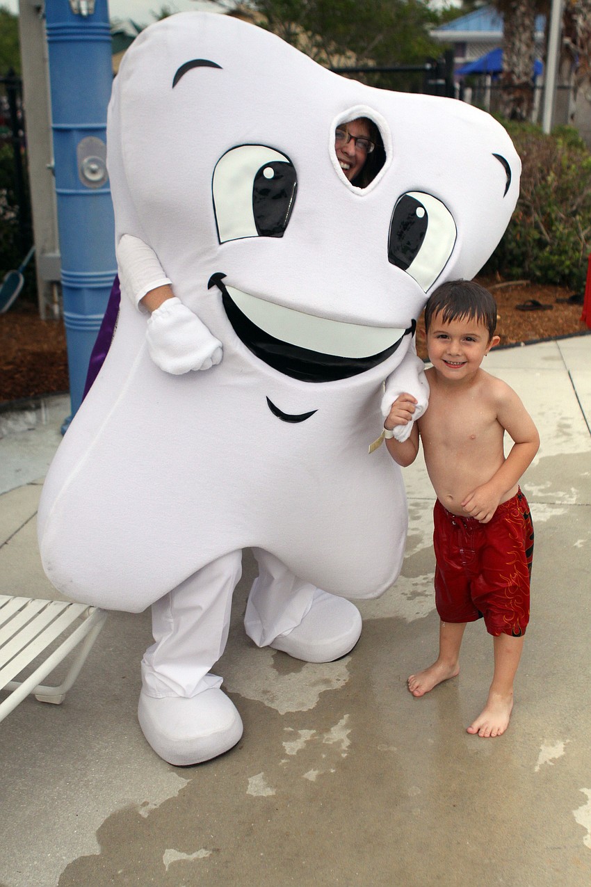 Carrie Betts from Orthodontists of Lakewood Ranch and Sarasota poses with Gage McDaniel, 6, during Healthy Kids Day at the Evalyn Sadlier Jones Branch of the Sarasota Y.