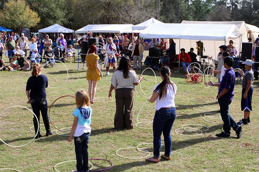 Kevin Loche gives a hoop dancing lesson, Saturday, Jan. 28, after his hoop dancing performance at the Sarasota Indian Festival.