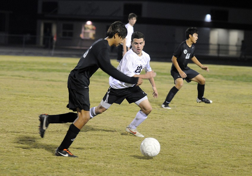 Lakewood Ranch junior midfielder David Cabrera looks to get past Braden River junior forward Fabio Vasconcellos.