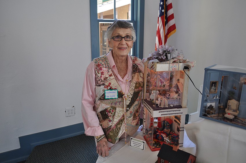 Lois Eastman poses with her miniature house displays.