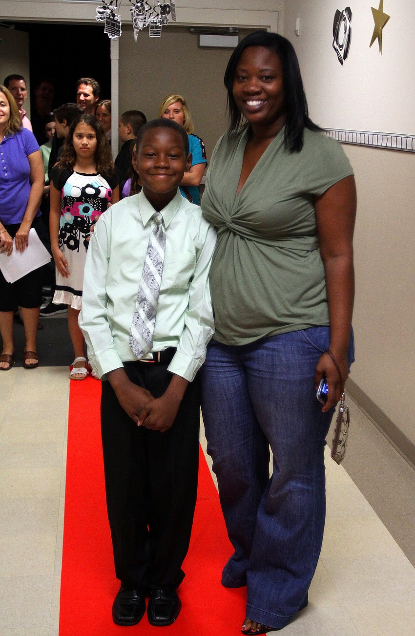 Travis, 10, and Shannon Mathews pose on the red carpet.