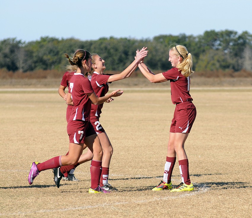 Braden River Soccer Club forward Jessica Schafer, right, is congratulated by her teammates following her goal.