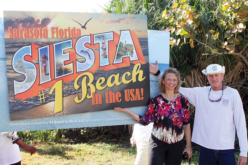 Kate Harrison, the designer of the sign,
and lifeguard Scott Ruberg