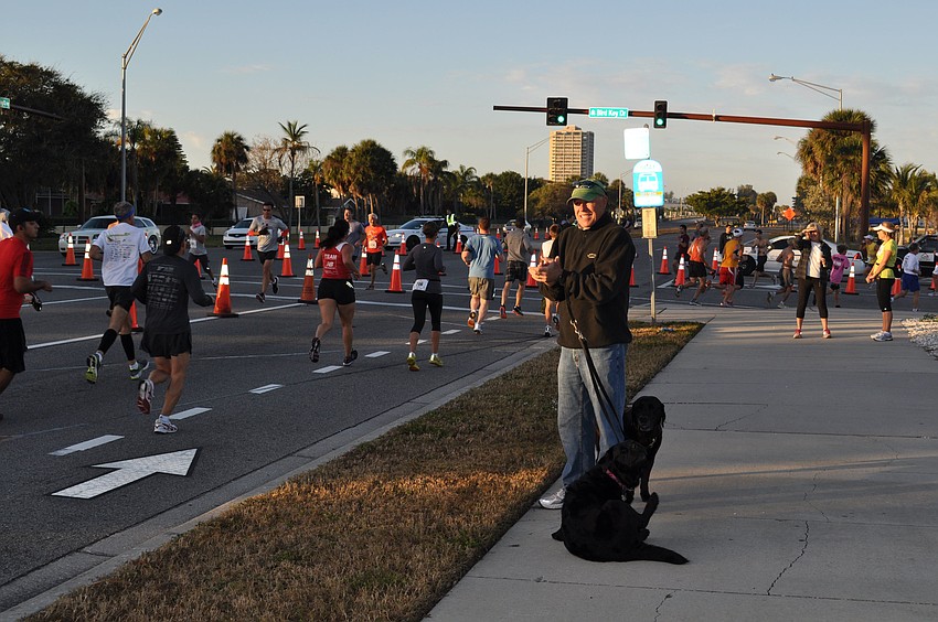 Mark Sheffield offers runners encouragement with the help of his dogs, Jasmine and Mayberry.