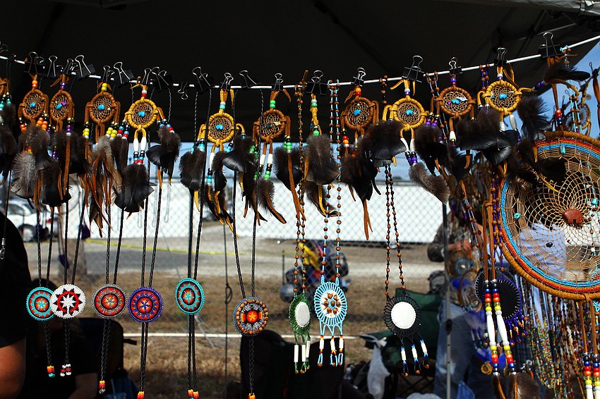 Bolo ties, medallions and dream catchers sway in the wind at Begay Indian Jewelry's booth at the Indian Festival.
