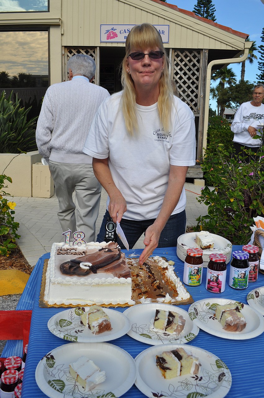 Grounds Supervisor Holly Baran cuts Williamsâ€™ cowboy-themed cake â€“ complete with candles saying â€œ18.â€