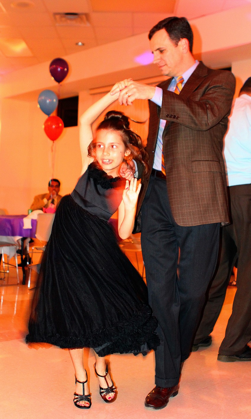Charlie Bailey twirls his daughter, Claire, 7, during a dance together.
