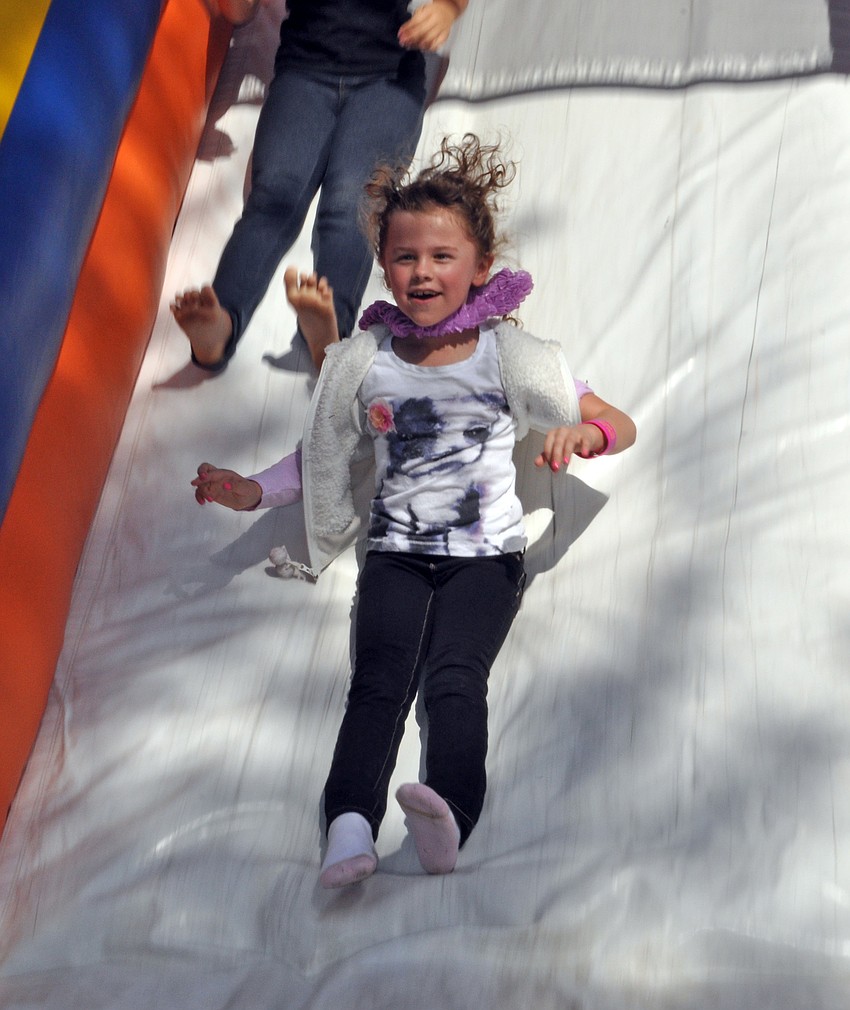 Seven-year-old Langley Carter made several trips down the bounce house slide.