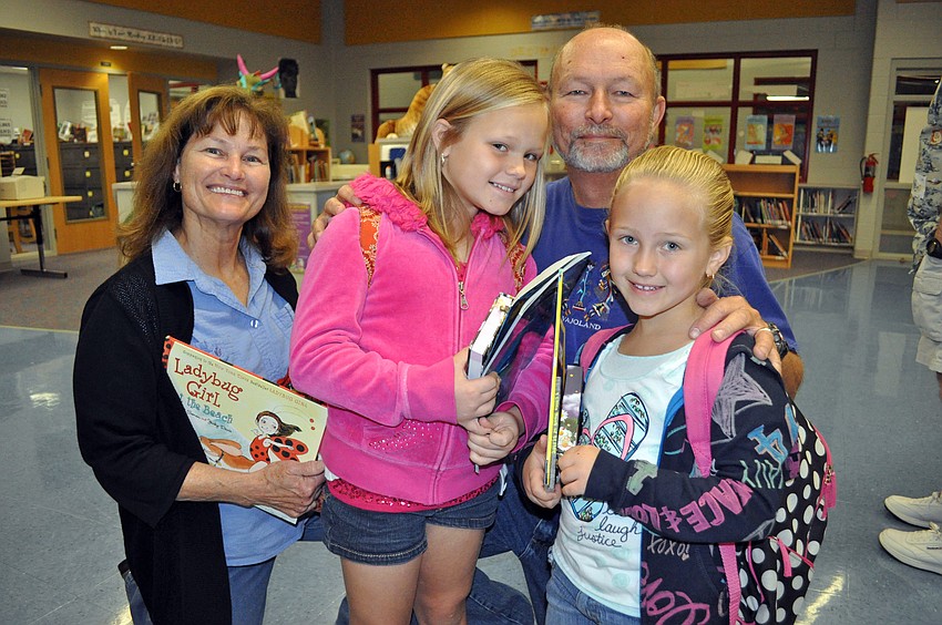 Ten-year-old Emma McIntyre and her younger sister Erin, 6, made sure to stop by the book fair with their grandparents Glen and Jean McIntyre.