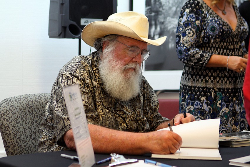 Clyde Butcher signs one of his books.