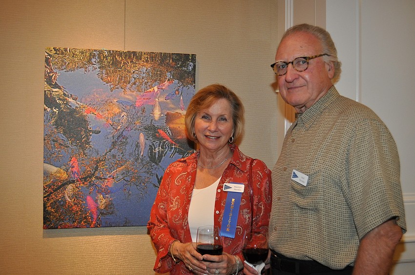 Marilyn and Jack Heridei in front of Marilynâ€™s work â€œAbove and Belowâ€ taken at Marie Selby Gardens.