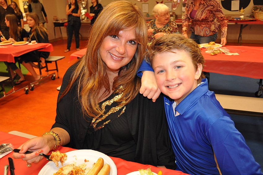 Angel Perkins, with her son, Solomon, enjoyed dinner before watching her daughter, Blessing, model in the fashion show.