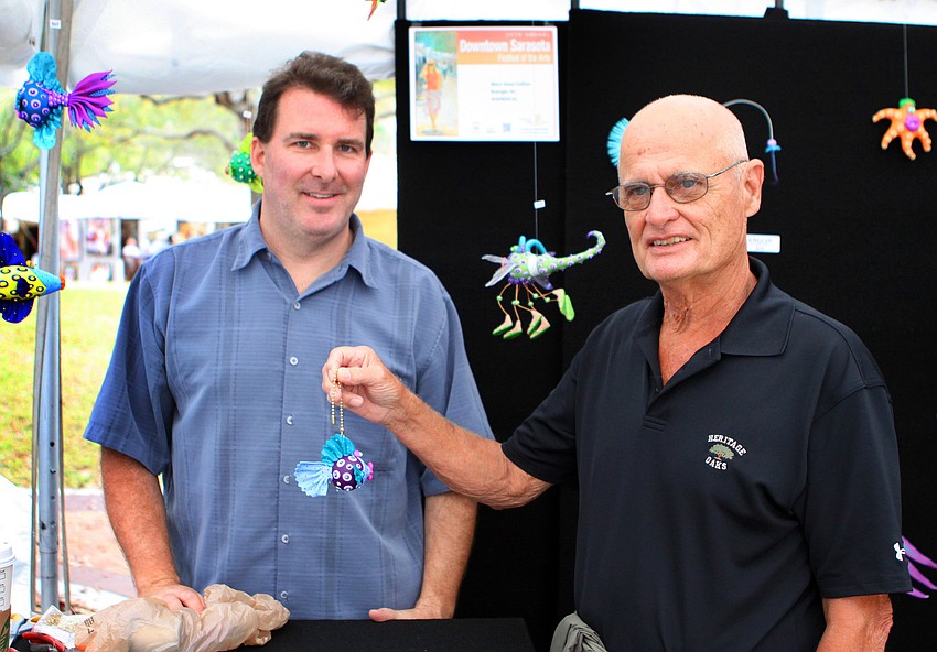 Gordon Willis bought a fun fish creation from Bill Collins of Whimsical at the 24th Annual Downtown Sarasota Art Festival, Sunday, Feb. 19.