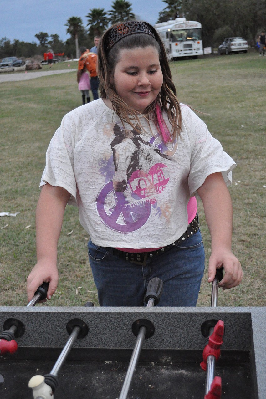 Caitlin Colwell took on her dad, Mark, not pictured, in a game of foosball.