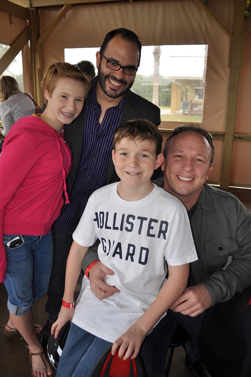 Lexi and Brandon Wilson are pictured with their dad, Jim, right, and Roger Capote, behind.