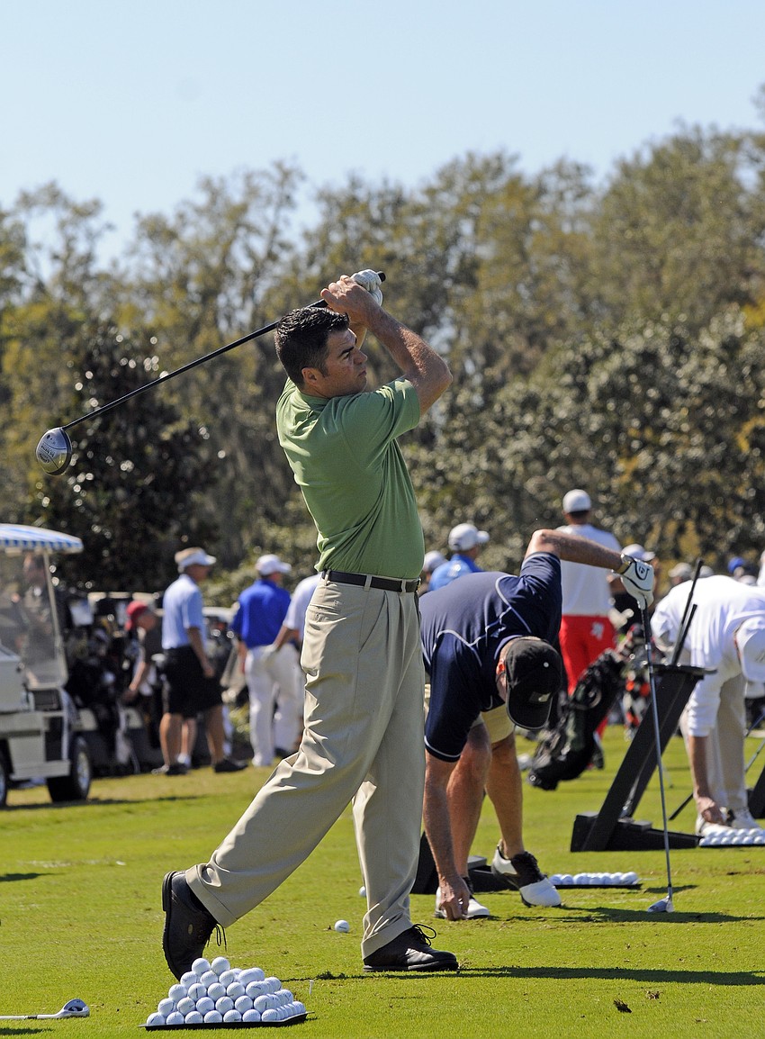 Former Junior Achievement Manatee/Sarasota board member Tim Mitten made sure to get in a few practice swings before the tournament.
