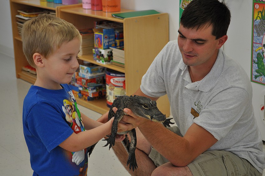 Jacob Cunningham loved the feel of Tinkerbellâ€™s skin. Also pictured is Dane Gottsch, right, of Sarasota Jungle Gardens.