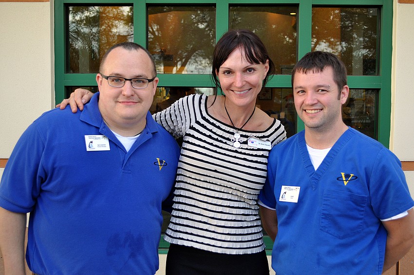 Nick Mayer, Dr. Anne Chauvet and Jaime Garza pose outside their office where Yappy Hour was held.