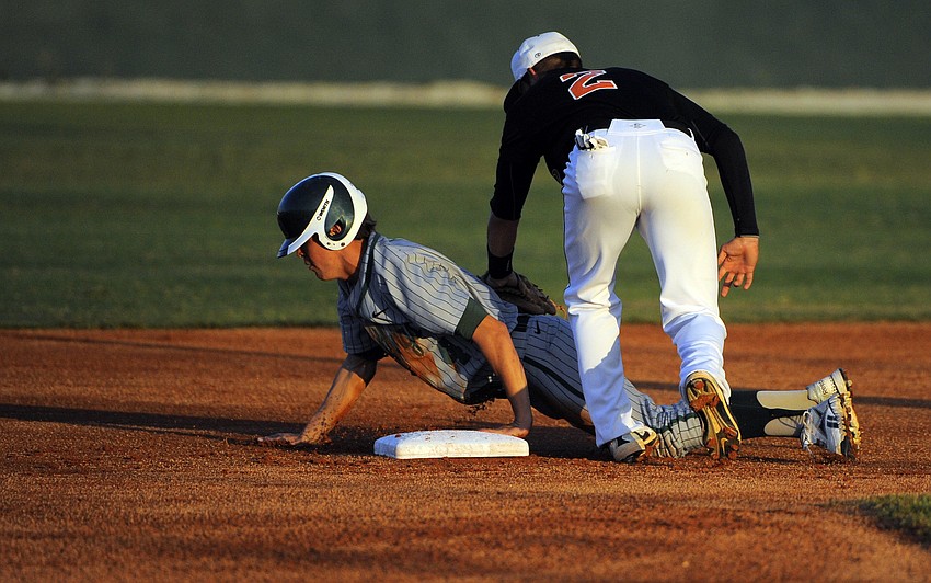 Lakewood Ranch shortstop Seth McGarry slides safely into second base during the Mustangs game against Sarasota March 14.