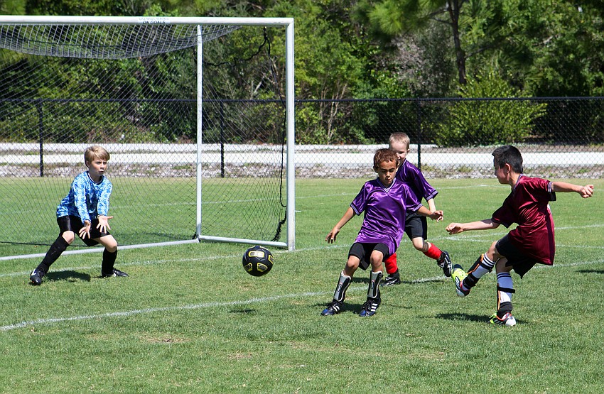 Henry Eladgren, 8, attempts to score a goal for his team the LA Express, Saturday, March 24.
