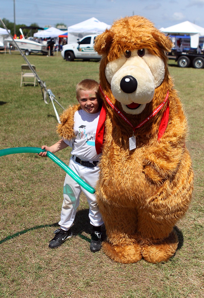 Christopher Angel, 7, poses with the Red Cross' Scrubby Bear.