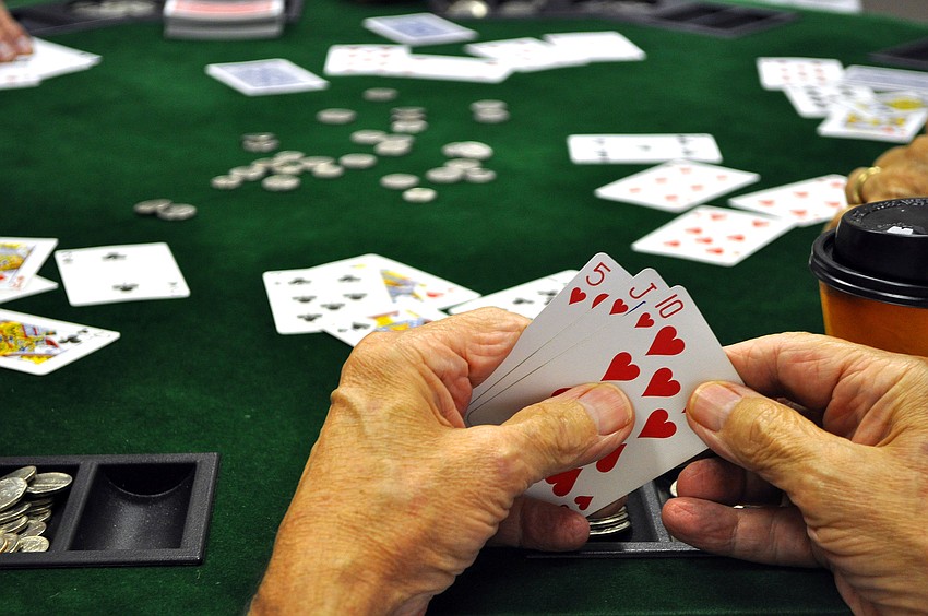 Robert Kaemerer looks at his hand during a game of poker, Tuesday, March 27.