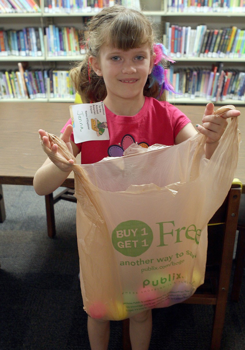 Jenna King, 9 Â½, shows off her bag of colorful, plastic eggs.