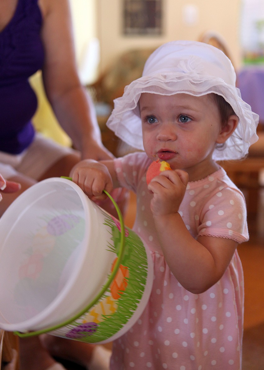 Anastasia McDonald, 17 mos., enjoys eating an egg shaped cookie.
