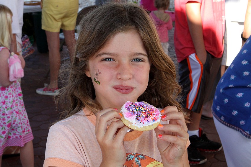 Anna Fortenberry enjoys her cookie that she decorated at St. Michael the Archangelâ€™s Easter egg hunt.