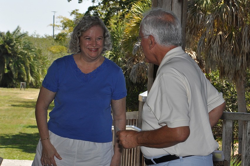 Christine Furgiuele presents Chet Pletzke, representing the Longboat Key Historical Society, a check for $200 to be used toward a new scanner