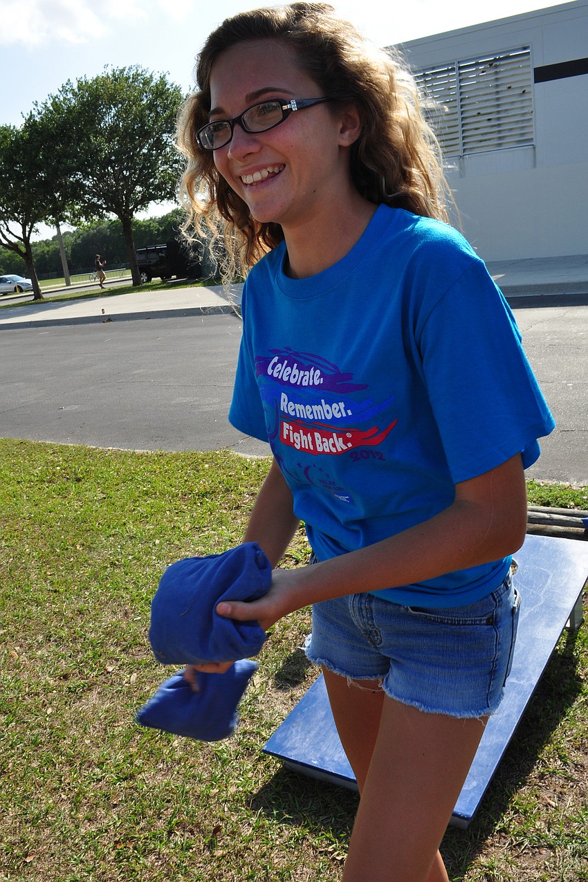 Julie Costanzo tried her skills at a game of corn hole.