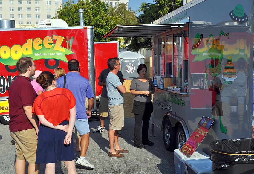 People stand in line to get sliders from Flying Sliders.