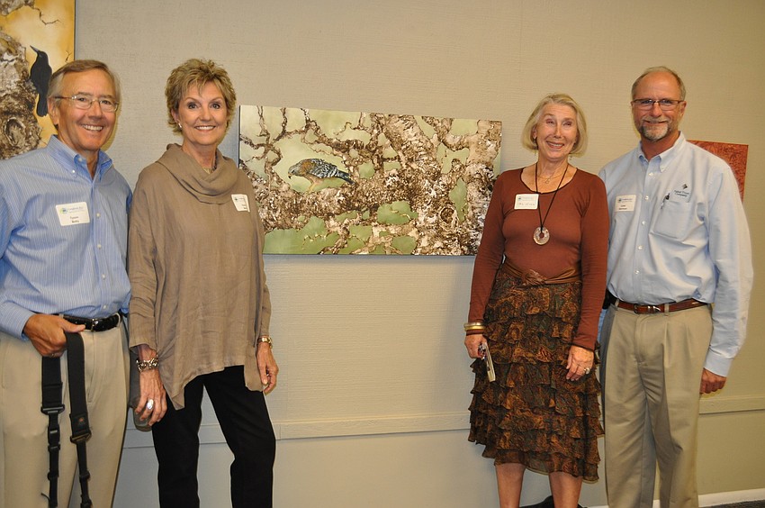 Tyson and Nancy Betty with Val Gill and Lowe Morrison in front of Nancy Bettyâ€™s piece â€œRed-Shouldered Hawkâ€