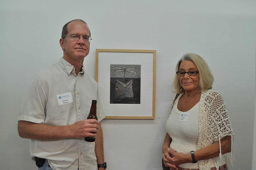 Richard Thomas and Gladys Plate in front of an untitled piece by Thomas
