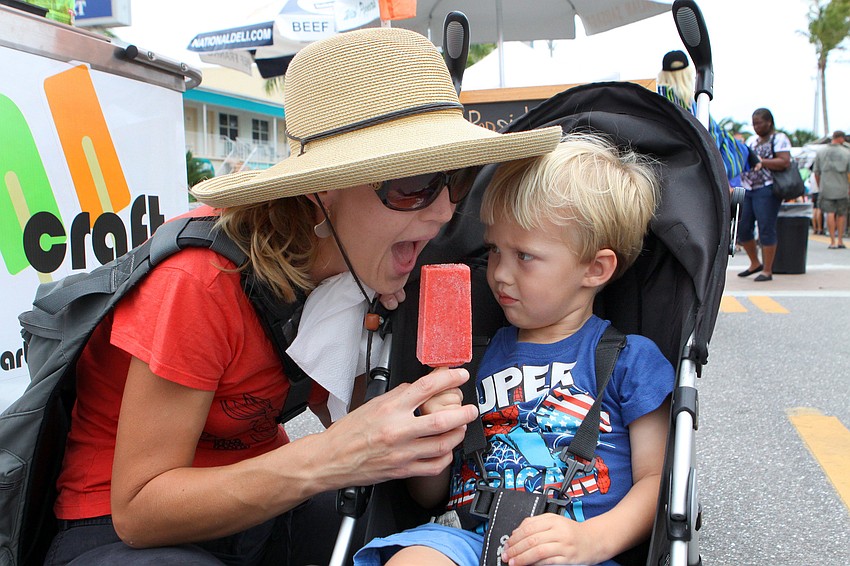 Kate Boyett tries to steal a lick from Asher Boyettâ€™s, 3, Pop Craft popsicle, Saturday, April 14, at Siesta Fiesta.