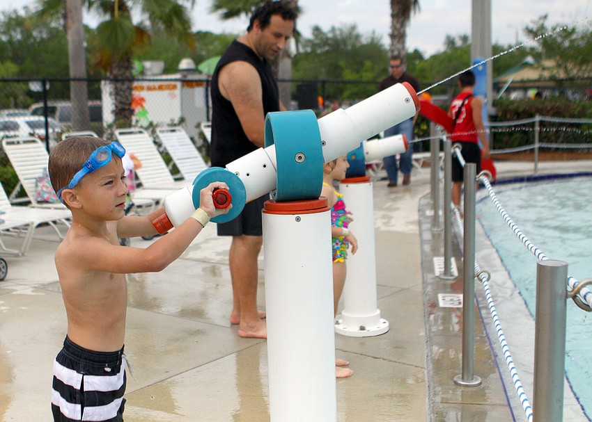 Temur Melnichenko, 6, has fun spraying people with one of the water guns.