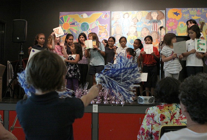 Some of the girls performed a cheer to the word â€œVolunteerâ€, Thursday, April 19, during the Girls Inc Volunteer Appreciation Day ceremony.
