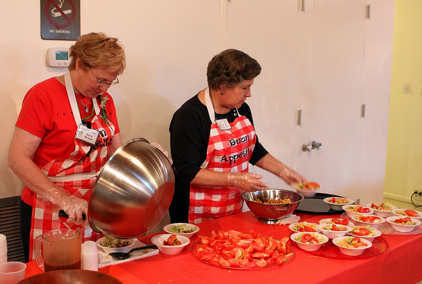 Sharon Davisson and Dorothy Thompson work on making the salads for the spaghetti dinner, Saturday, Jan. 7 at the Sarasota Garden Club.