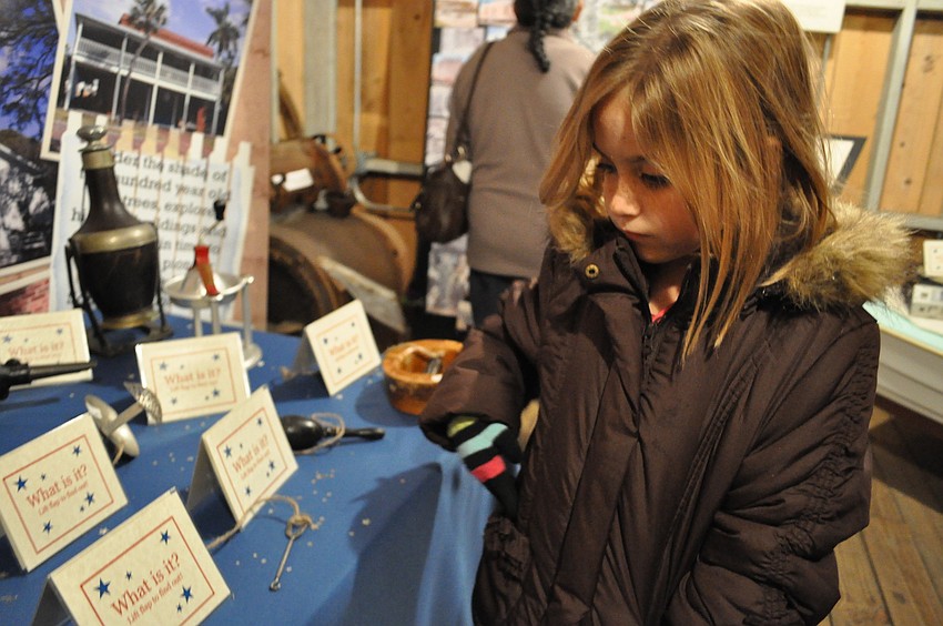 Seven-year-old Allie Heath checked out antiques on display in the Harlee Barn.